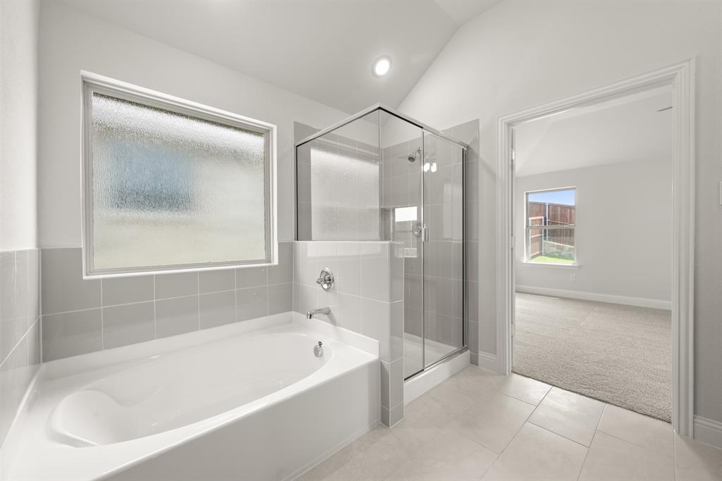 228 Shepards Street Godley, TX 76044 - Photo 10 of 27 a bathroom with a bathtub and a shower