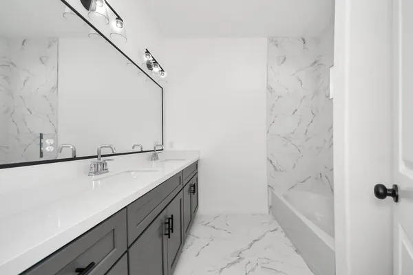 a bathroom with a sink and mirror