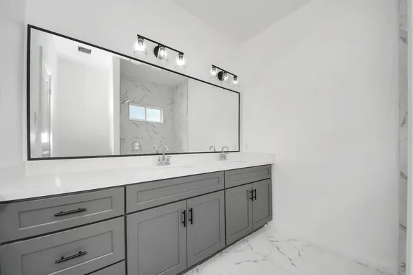 a bathroom with a sink and mirror