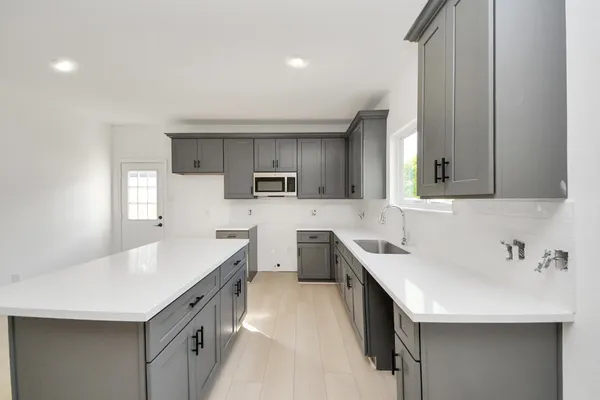a kitchen with stainless steel appliances a sink stove and cabinets