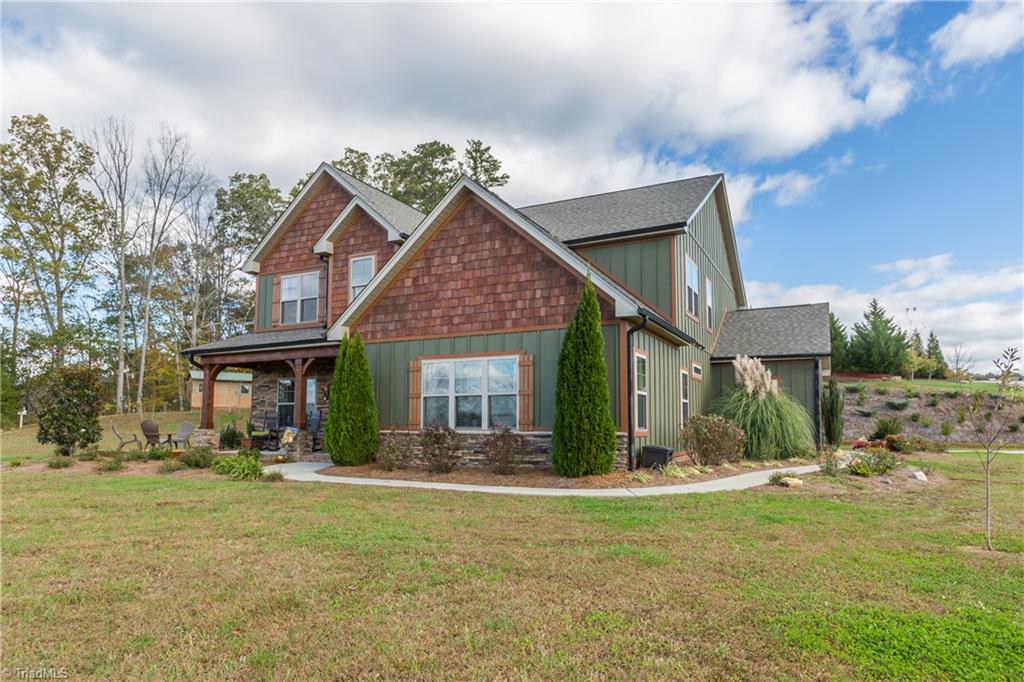 Mature professional landscaping surrounds the home