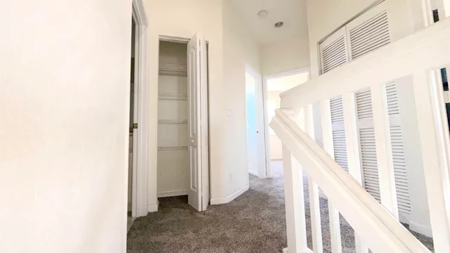 a spacious bathroom with a granite countertop sink a mirror and a bathtub