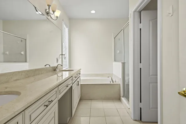 a bathroom with a bath tub with shower