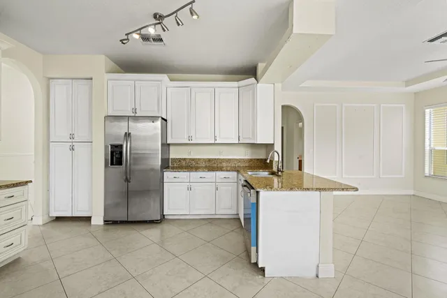 a kitchen with a stove sink and refrigerator