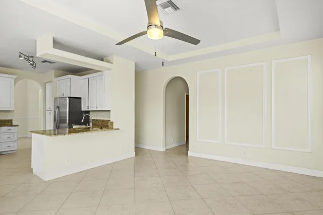 a view of a kitchen with furniture and a ceiling fan