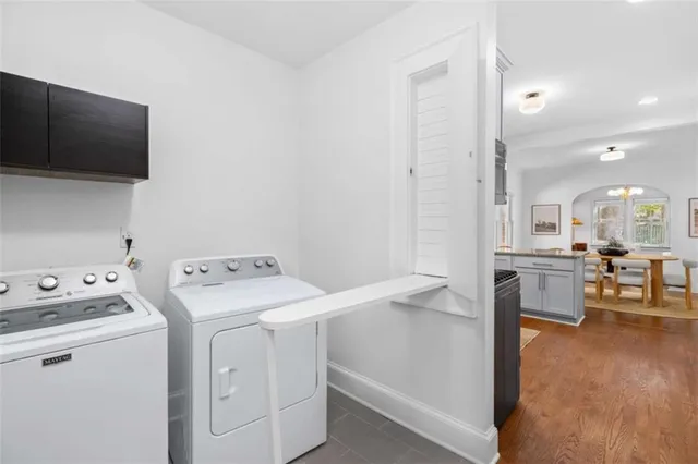 a view of washer and dryer with kitchen in the background