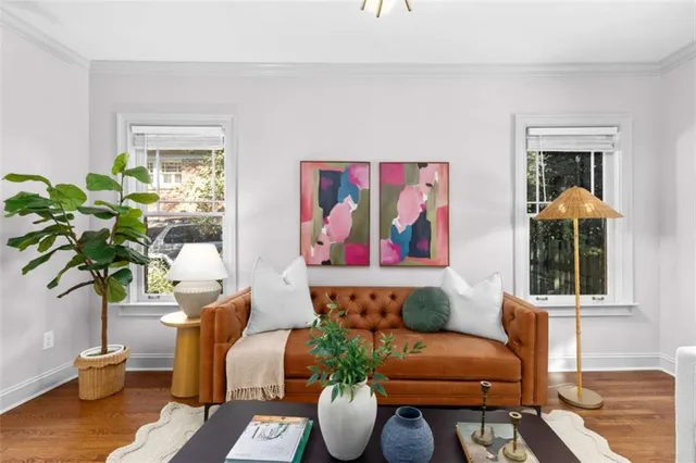 a living room with furniture flowerpot and wooden floor