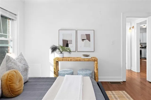 a bedroom with bed and wooden floor