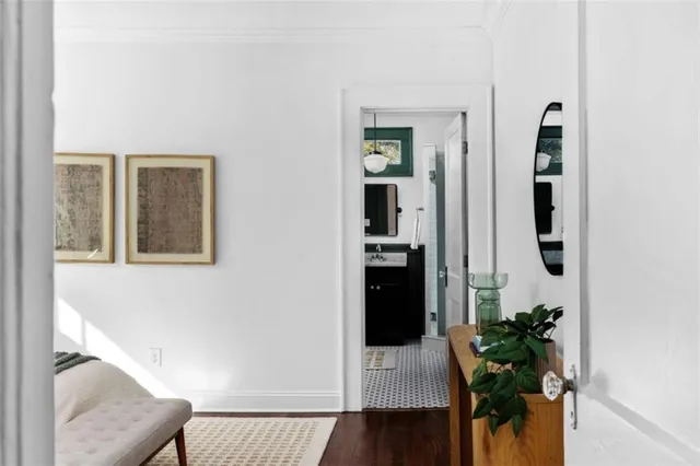 a bedroom with bed and wooden floor