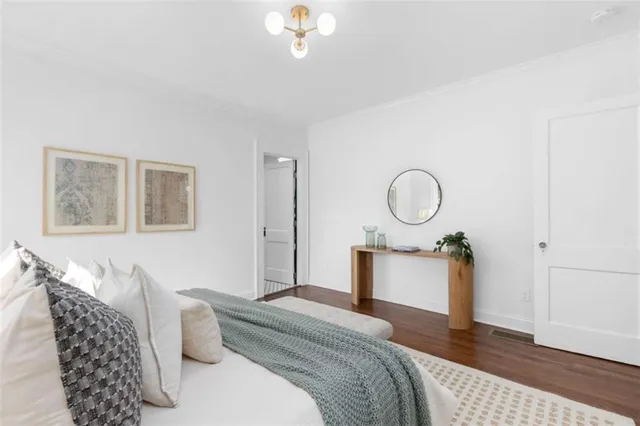 a bedroom with bed and wooden floor