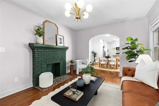 a living room with furniture a fireplace and a potted plant