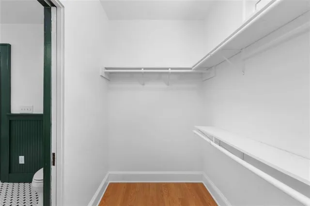 a front view of a house with a yard covered with snow and trees