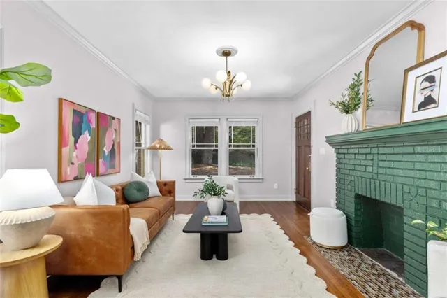 a living room with furniture potted plant and a fireplace