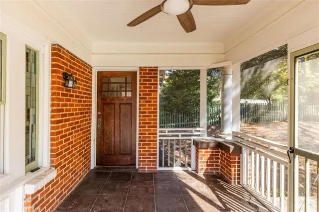 a view of a house with wooden fence next to a road
