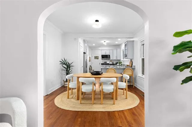 a dining room with furniture and wooden floor