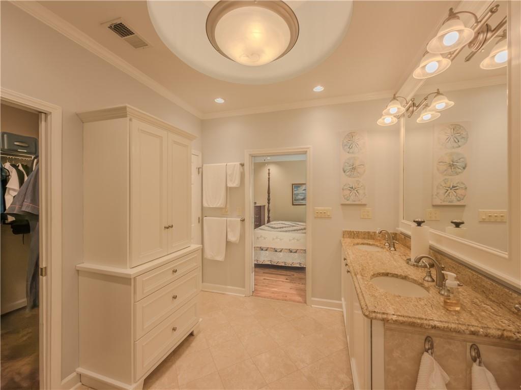 4284 Cedar Bluff Way Southwest Lilburn, GA 30047 - Photo 19 of 62 a spacious bathroom with a double vanity sink a mirror and a bathtub