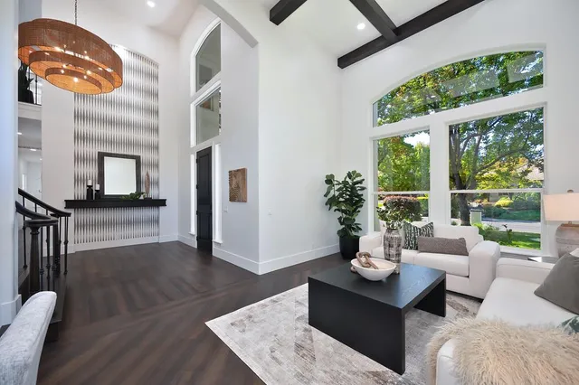 a kitchen with stainless steel appliances granite countertop a sink a stove and a wooden floors