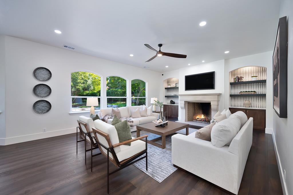 9042 Cedar Ridge Drive Granite Bay, CA 95746 - Photo 16 of 96 a living room with furniture a fireplace and a flat screen tv