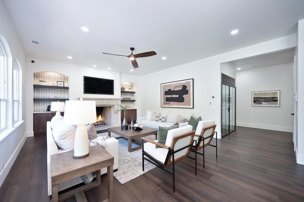 9042 Cedar Ridge Drive Granite Bay, CA 95746 - Photo 18 of 96 a living room with furniture a fireplace and a flat screen tv