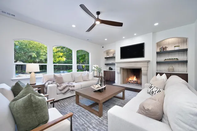 a living room with furniture or chandelier and a wooden floor