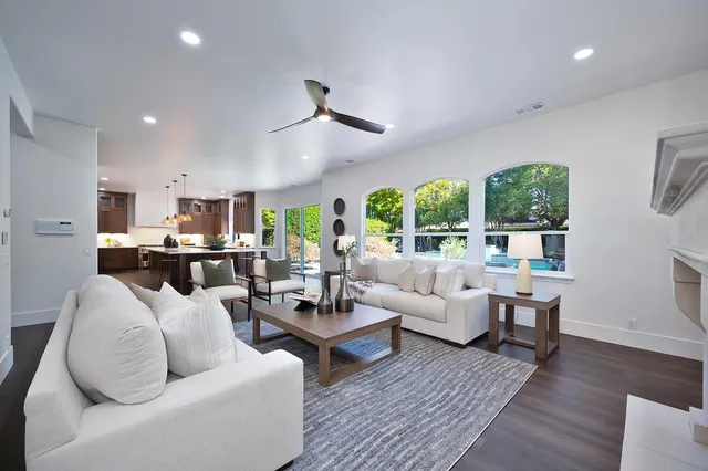 a living room with furniture chandelier and a window