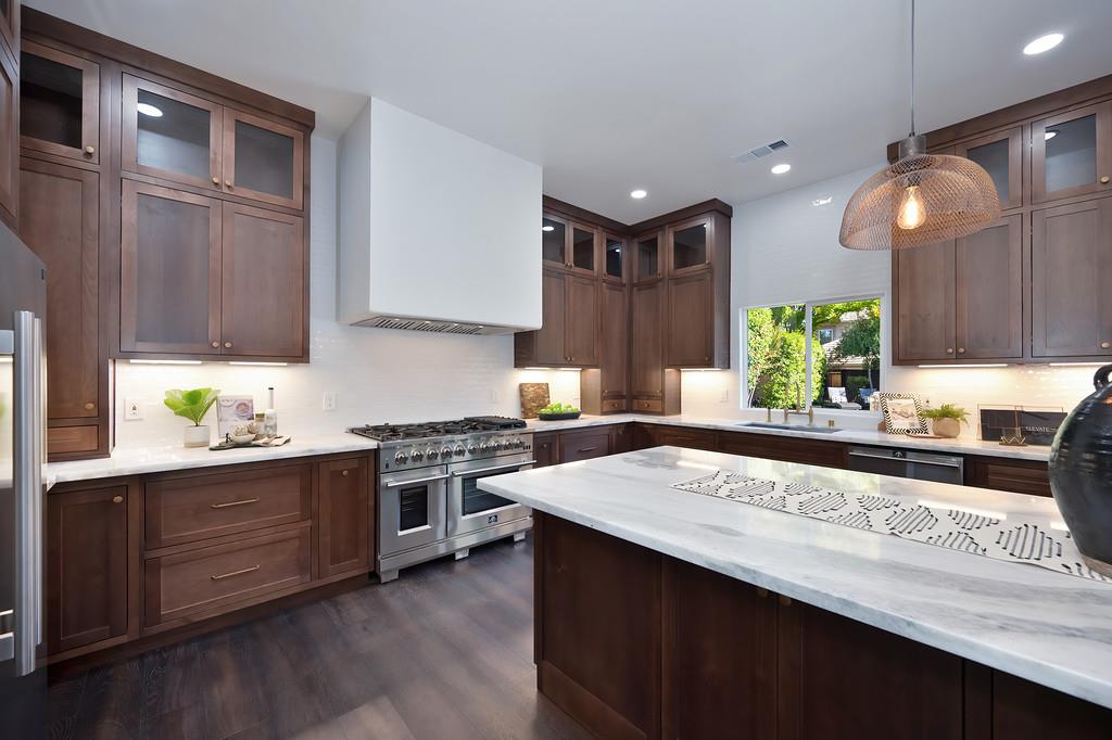 9042 Cedar Ridge Drive Granite Bay, CA 95746 - Photo 30 of 96 a kitchen with stainless steel appliances kitchen island granite countertop wooden cabinets and a sink
