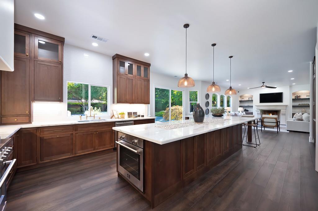 9042 Cedar Ridge Drive Granite Bay, CA 95746 - Photo 31 of 96 a kitchen with stainless steel appliances granite countertop a sink a stove and a wooden floors