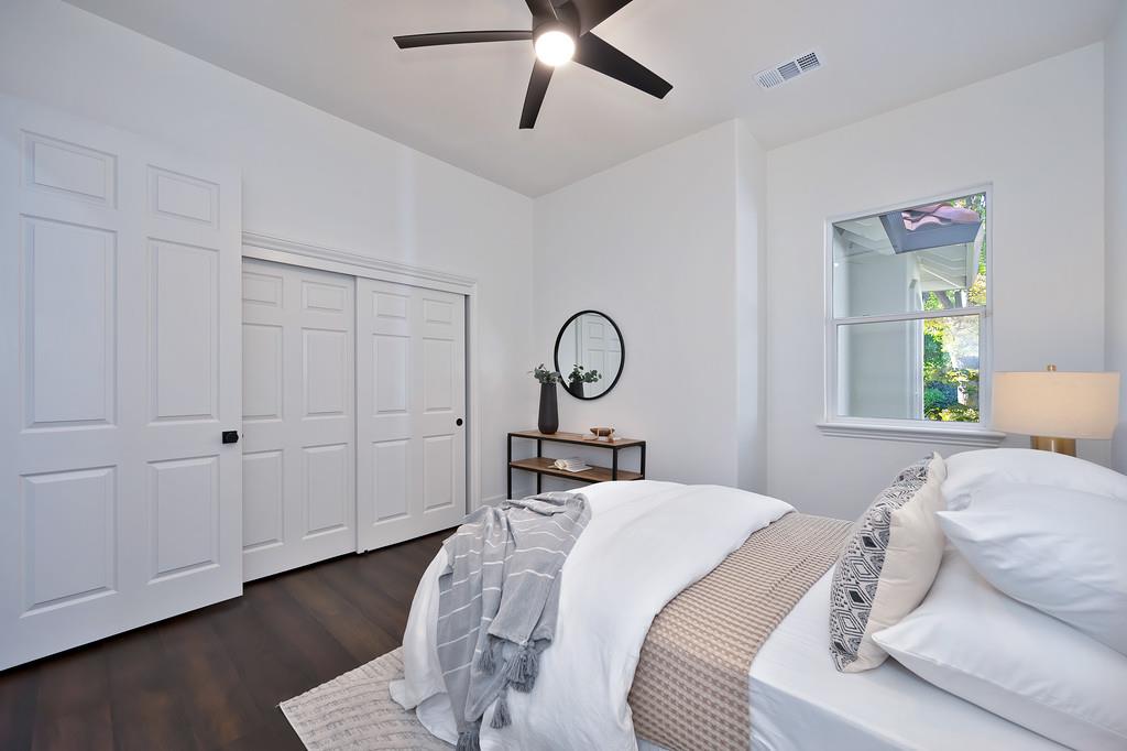 9042 Cedar Ridge Drive Granite Bay, CA 95746 - Photo 47 of 96 a bedroom with a bed and a chandelier