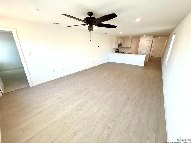 a view of a kitchen with a sink and a refrigerator