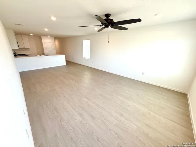 a bedroom with a bed couch and a window