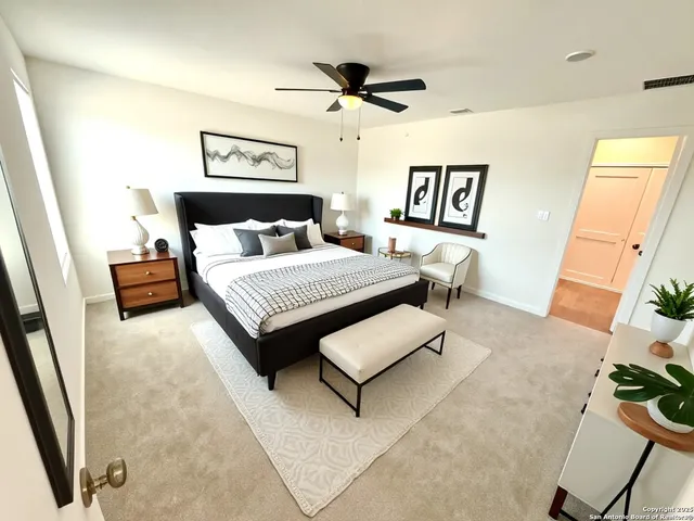 a view of a room with a ceiling fan