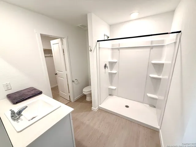 a bathroom with a shower and toilet