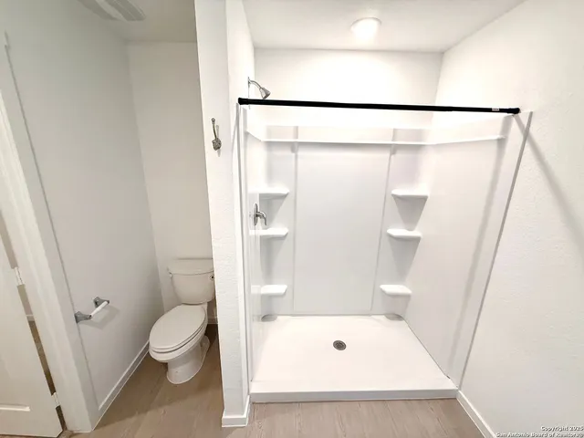 a utility room with cabinets washer and dryer