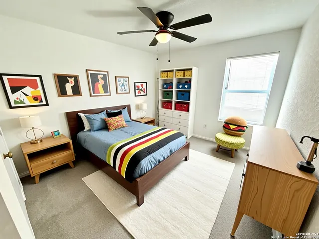 an empty room with a window and a fan