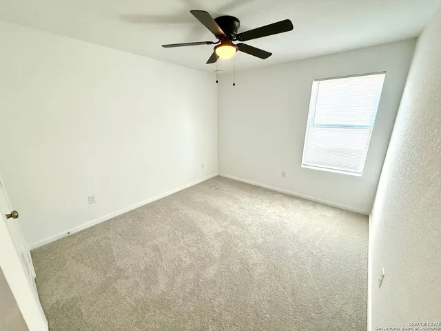 a view of a room with a ceiling fan