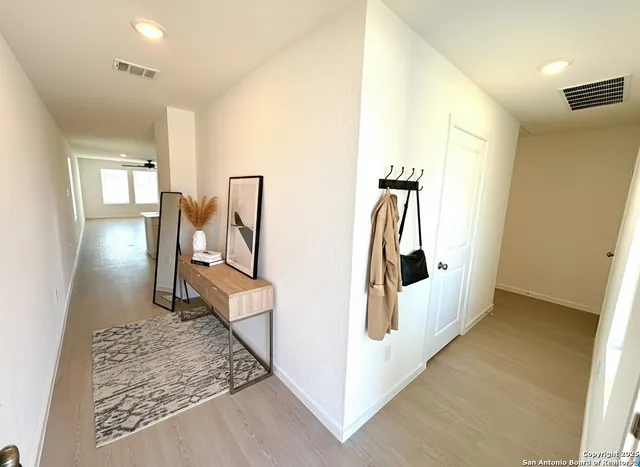 a view of a hallway with wooden floor
