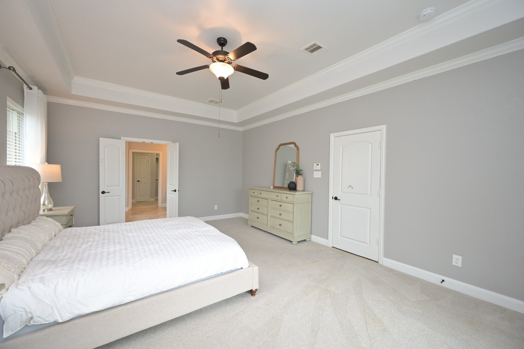 11 South Victoriana Circle Spring, TX 77389 - Photo 20 of 38 a bedroom with a large bed and a chandelier