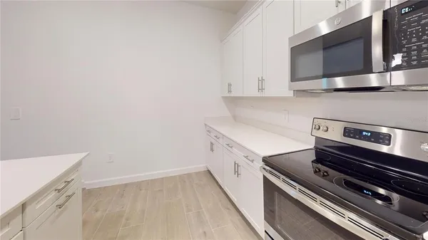 a kitchen with a stove and a microwave