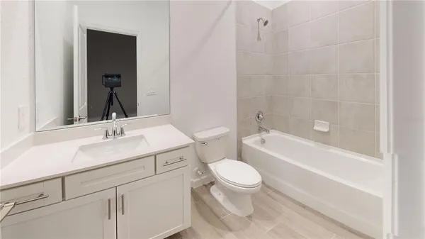 a bathroom with a sink toilet vanity and shower