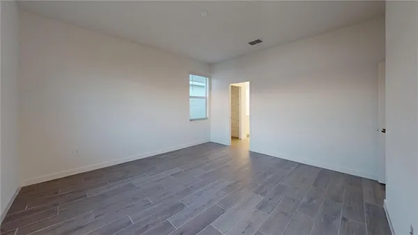 a view of an empty room and wooden floor