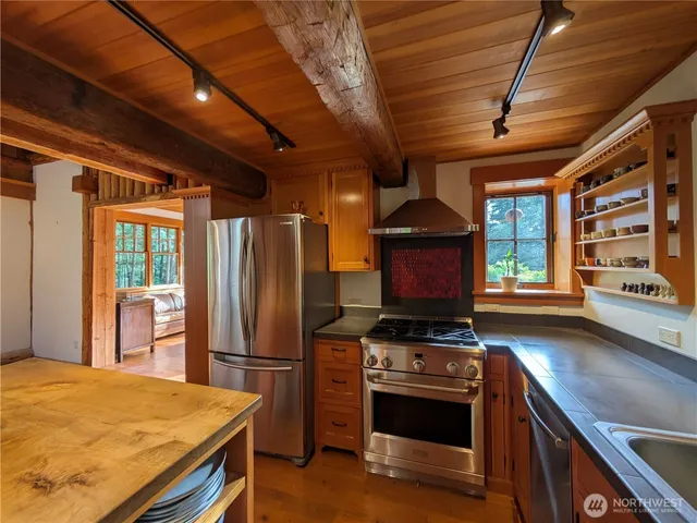 a kitchen with stainless steel appliances granite countertop a stove and a refrigerator