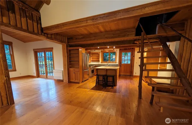 wooden floor in a hall with a table and chairs