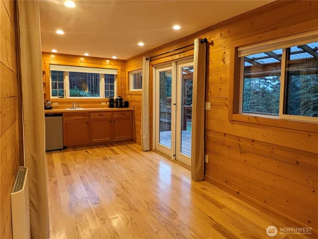 a open kitchen with window and wooden floor