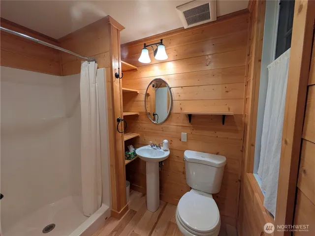 a bathroom with a toilet sink and shower