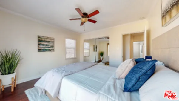 a bedroom with a bed and a potted plant