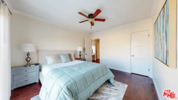a bedroom with a bed and a ceiling fan