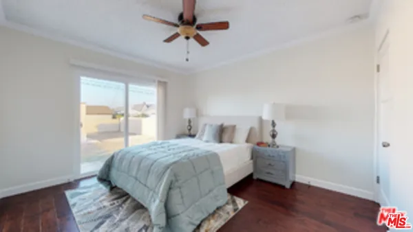 a bedroom with a bed a window and a chandelier