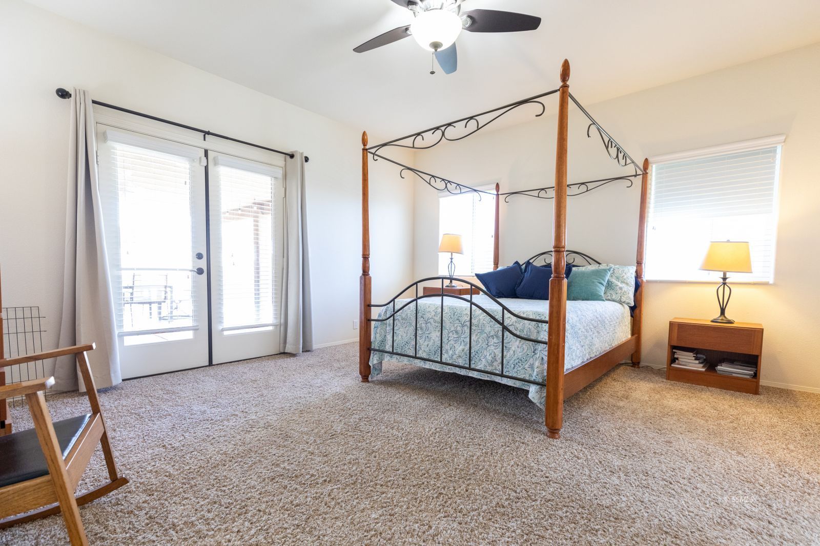 428 South Inyo Street Ridgecrest, CA 93555 - Photo 20 of 33 a spacious bedroom with a bed a chandelier and a window