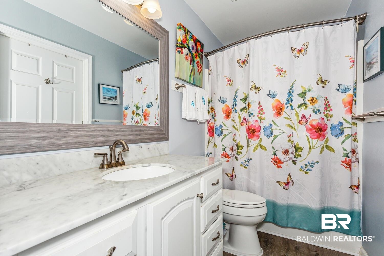 13551 Johnson Beach Road, Unit 112E Pensacola, FL 32507 - Photo 17 of 42 Full bathroom with toilet, vanity, wood-type flooring, and shower / bath combo with shower curtain
