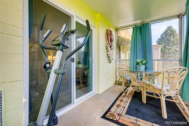 a view of a hallway with furniture and a window